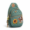 Teal quilted sling bag with sunflower and butterfly transfers on white background